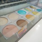 Ice cream tubs in a display freezer.