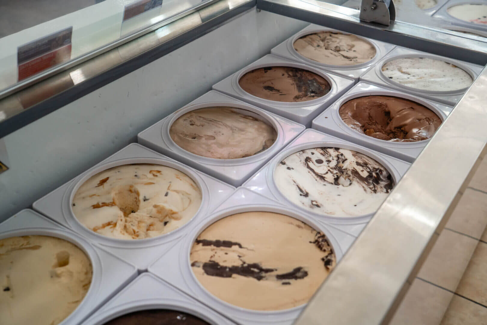 Ice cream tubs in a display freezer.