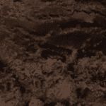 Dark textured abstract surface with rough patterns.