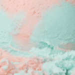 Pastel pink and teal textured surface.