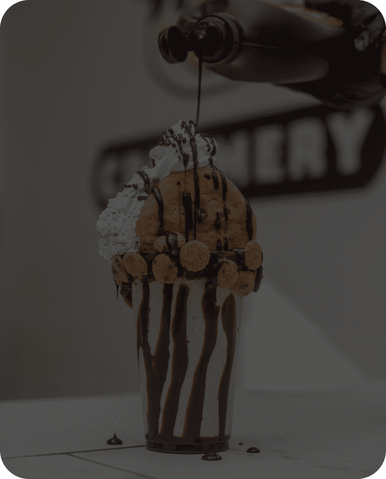 Chocolate drizzle on a decadent ice cream dessert.