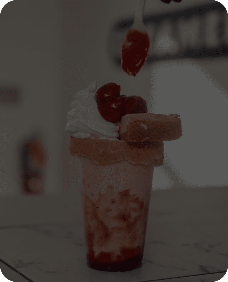 Milkshake with whipped cream and strawberries.