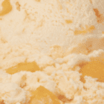 Peach ice cream with visible fruit chunks.