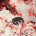 Ice cream with chocolate and berry swirls.