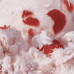 Strawberry ice cream with red swirls.